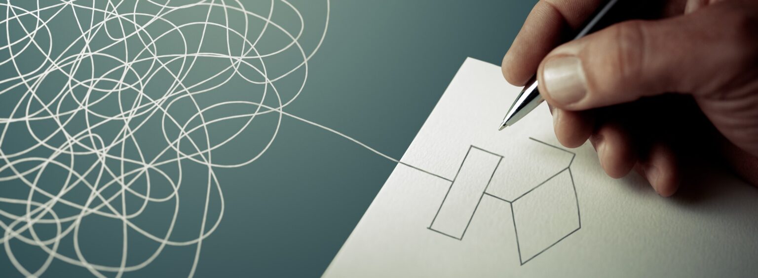 A hand drawing a clean geometric shape with a single line emerging from a tangled scribble