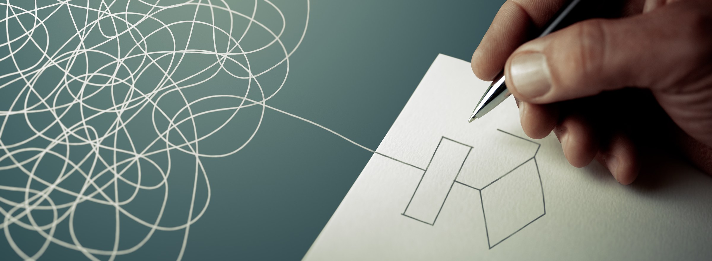 A hand drawing a clean geometric shape with a single line emerging from a tangled scribble